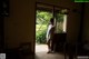 A woman standing in front of a sliding glass door.