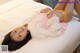 A woman laying on top of a white bed.