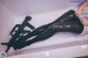 A woman laying in a bathtub with a gun in her hand.